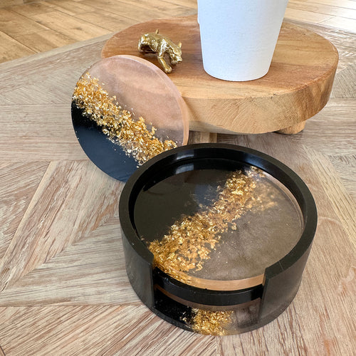 Goudvlokken, champagne en zwart onderzetters met houder